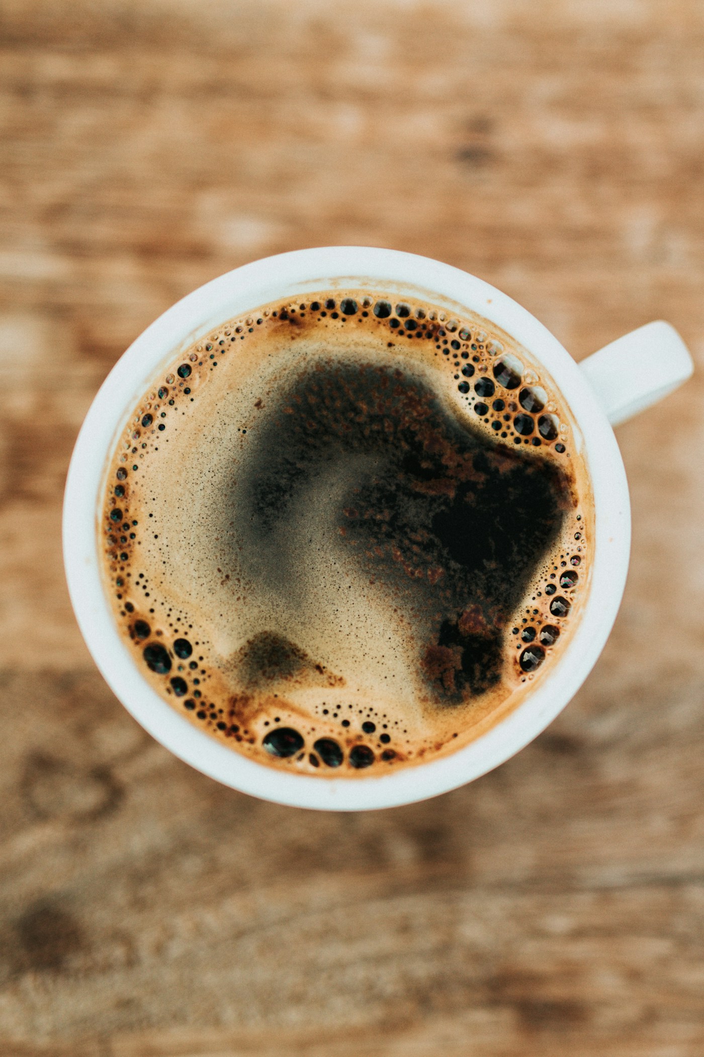Kopi in a thick glass, still settling